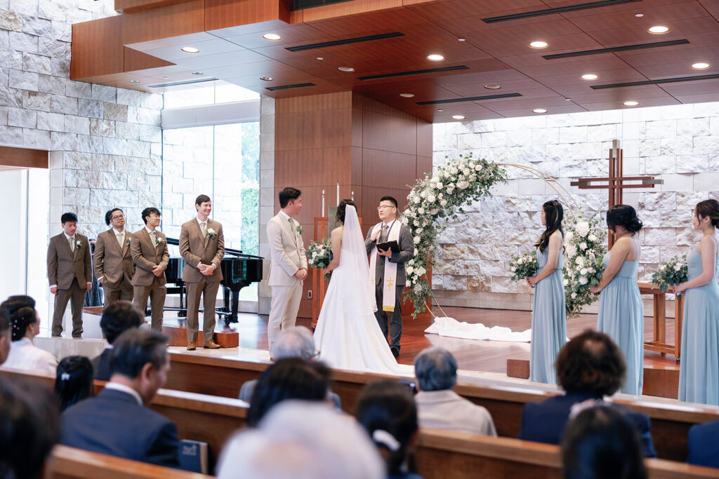 bride and groom stand at the alter crossline wedding 