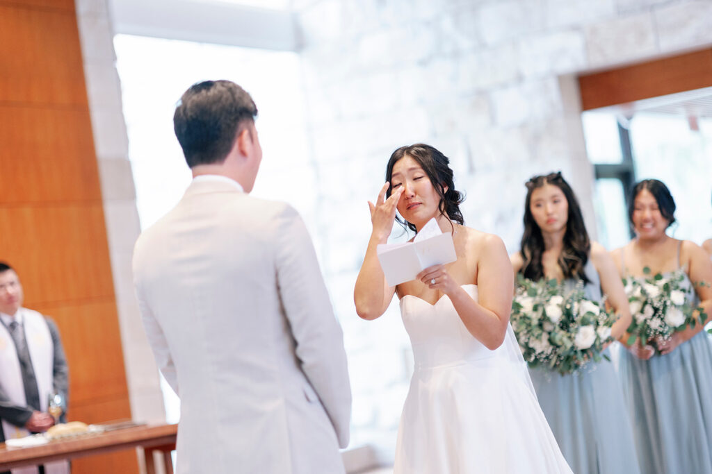 bride tears up reading vows at community church wedding in Laguna 