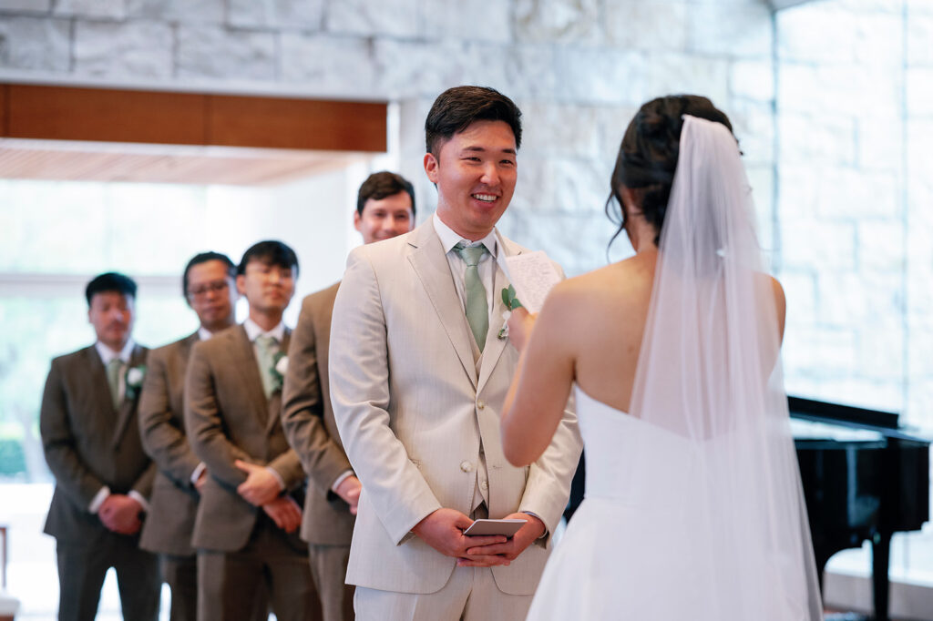 groom smiles during ceremony at crossline church