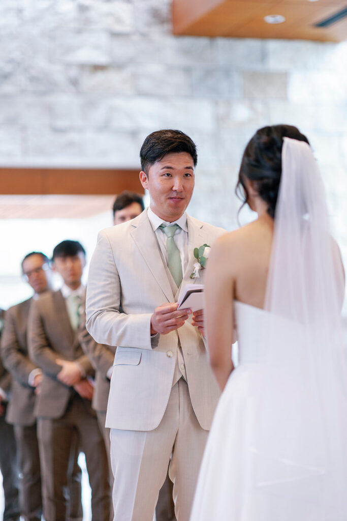 reading vows to his bride at community wedding