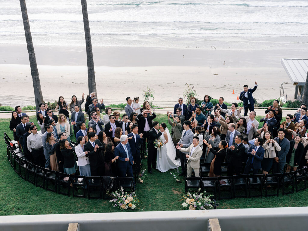 group shot of family and friends at seaside wedding scripps