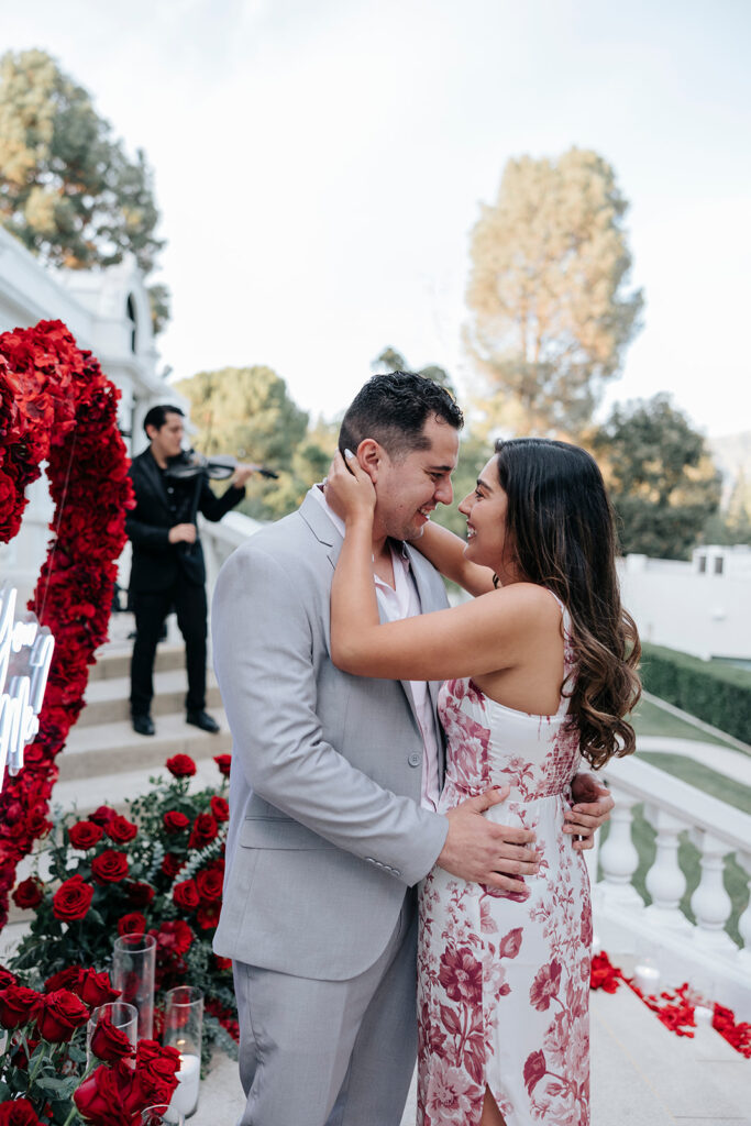 Man and woman embrace after proposal at Pasadena Museum of History.