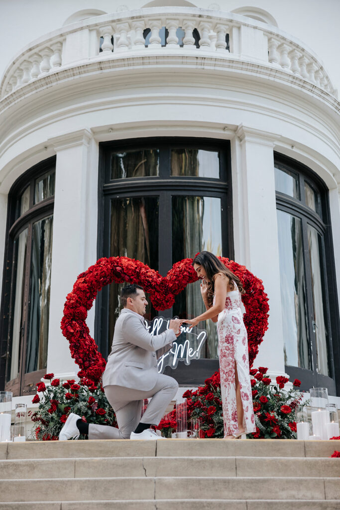 Surprise proposal at Pasadena Museum of History with red heart-shaped rose floral installment. 