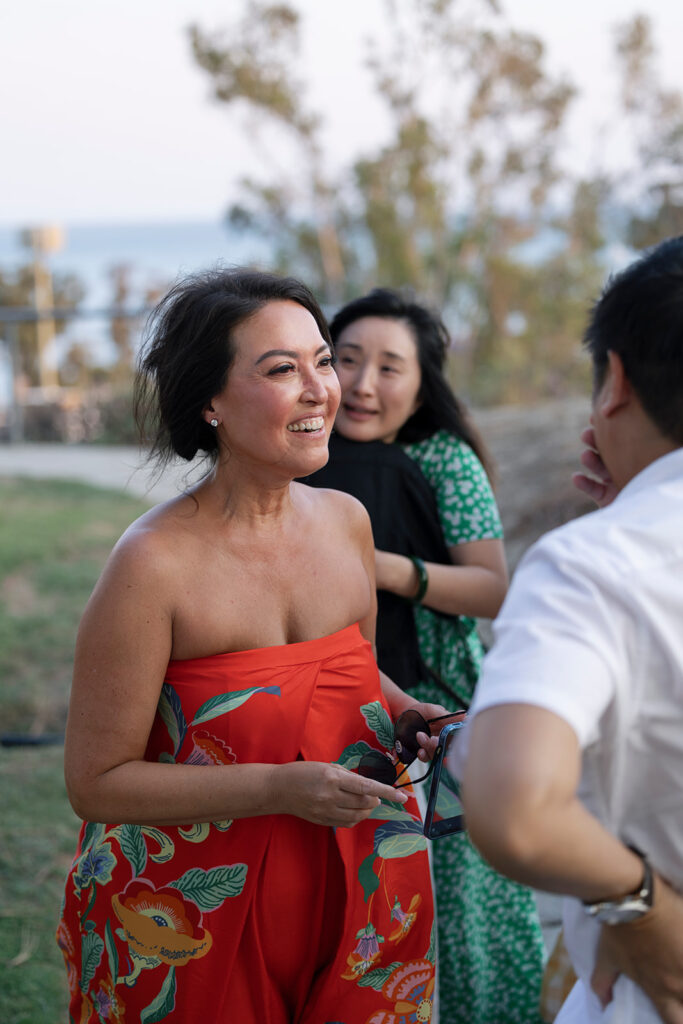 Family member congratulates newly engaged couple at Dana Point.