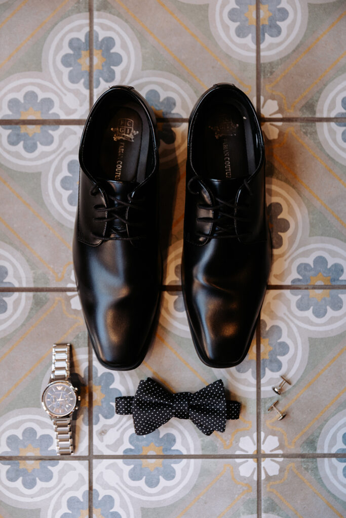 grooms black shoes, bow tie, watch and cuff links