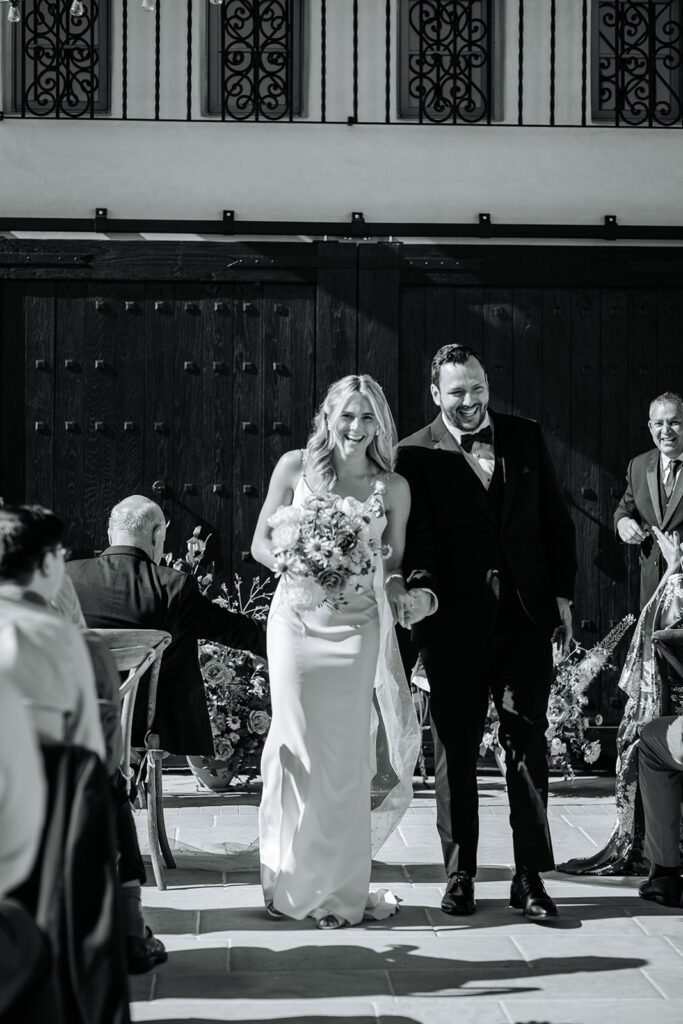 bride and groom leaving ceremony at wedding at agape 1928 in san clemente