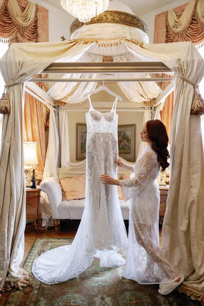 bride admiring bridal gown