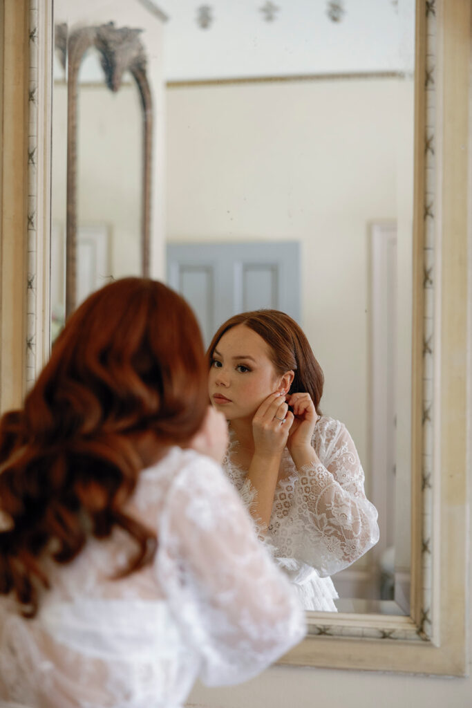 bride putting on earrings