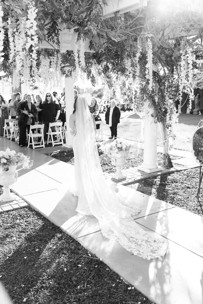 bride coming down the aisle for garden inspired wedding ceremony 