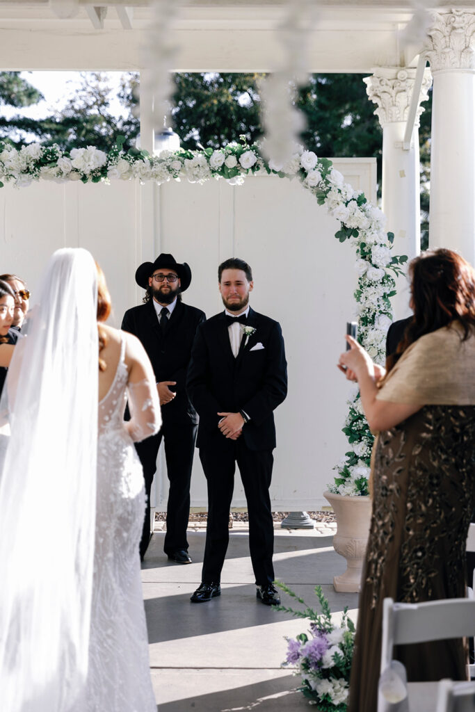 groom tearing up while seeing his bride at jefferson street mansion wedding 