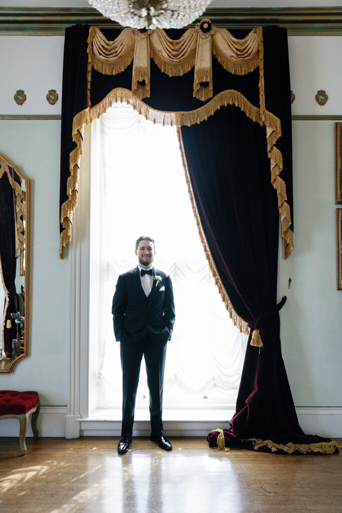 groom portrait by window