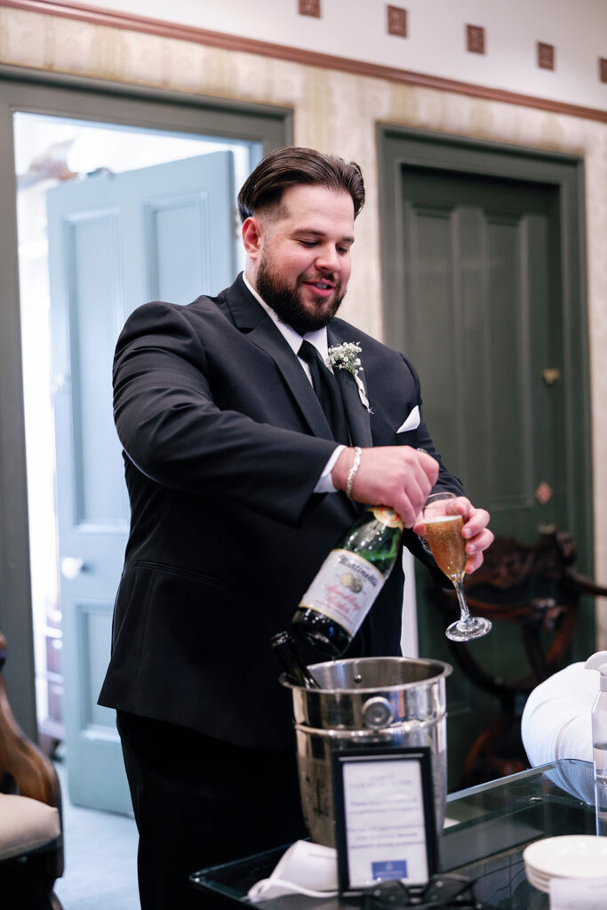 groomsman pouring champagne 