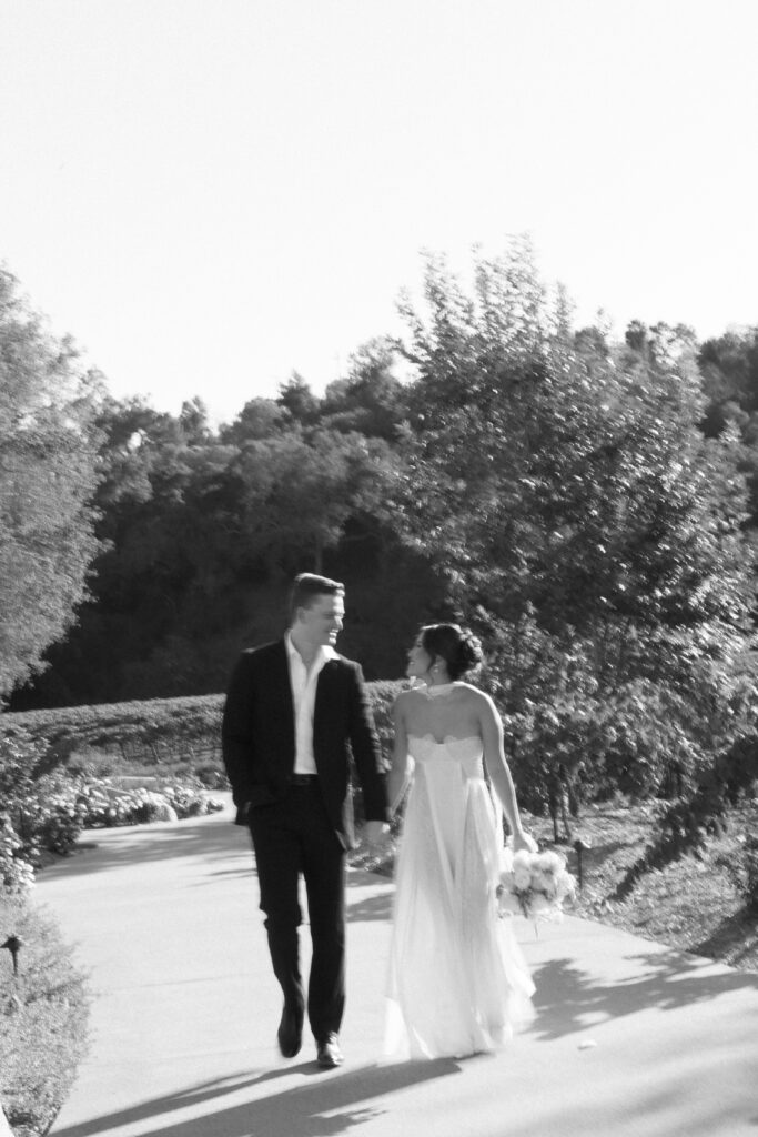 black and white shot of groom and bride outside during golden hour | 2025 wedding trends