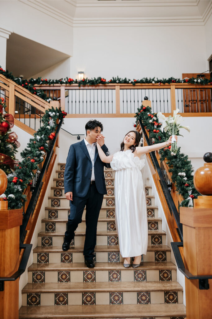 Bride and groom walk down steps of Laguna Hills Civic Center after city hall elopement in Orange County.