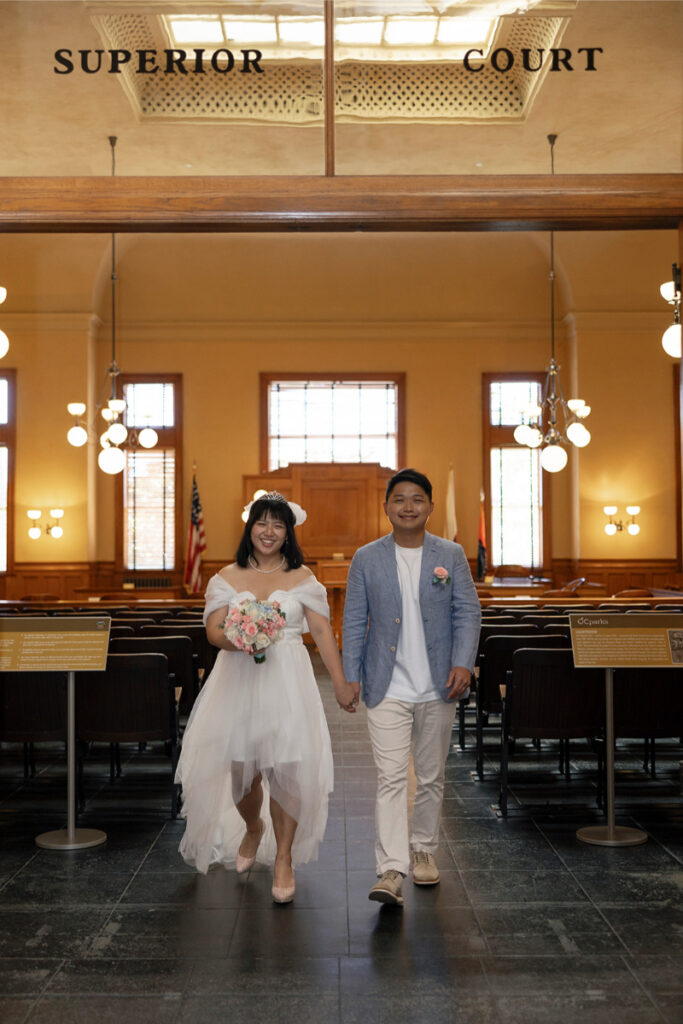 Bride and groom exit Old Orange County Courthouse after their elopement. 