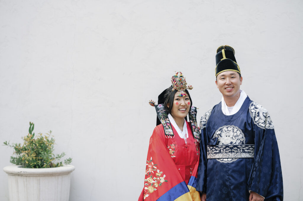 A happy couple wearing traditional Korean hanbok