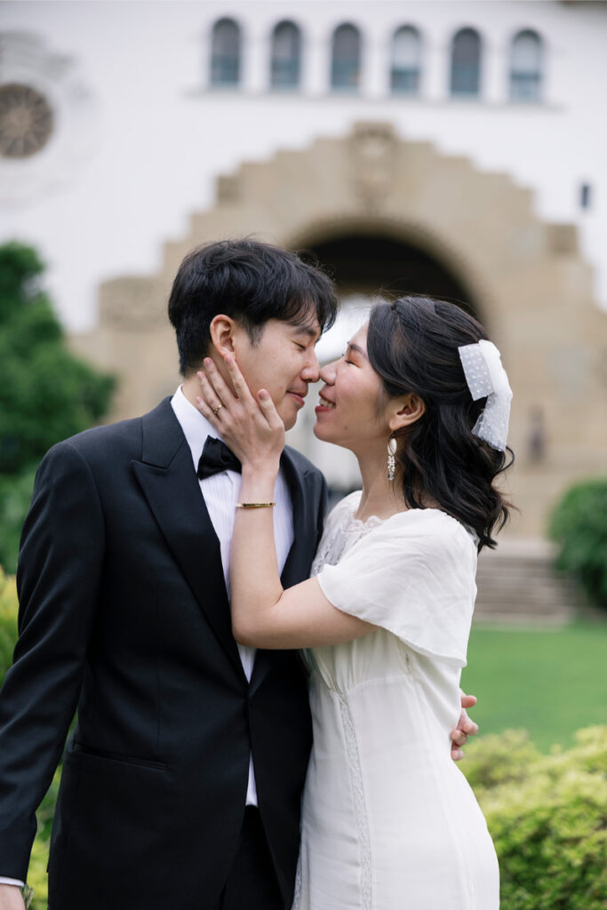 Bride and groom embrace for their wedding portraits after city hall elopement in Orange County. 