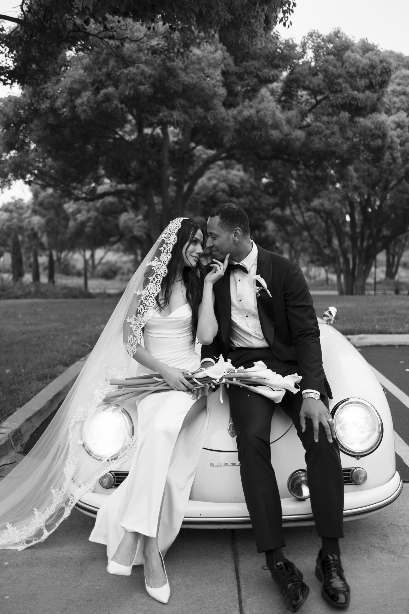 A couple sharing an intimate moment in a vintage car, a perfect addition to their photos of getting engaged in Orange County.